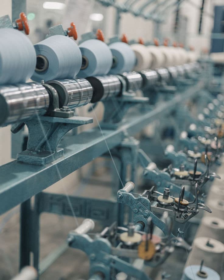 Rows of yarn cones on a winding machine